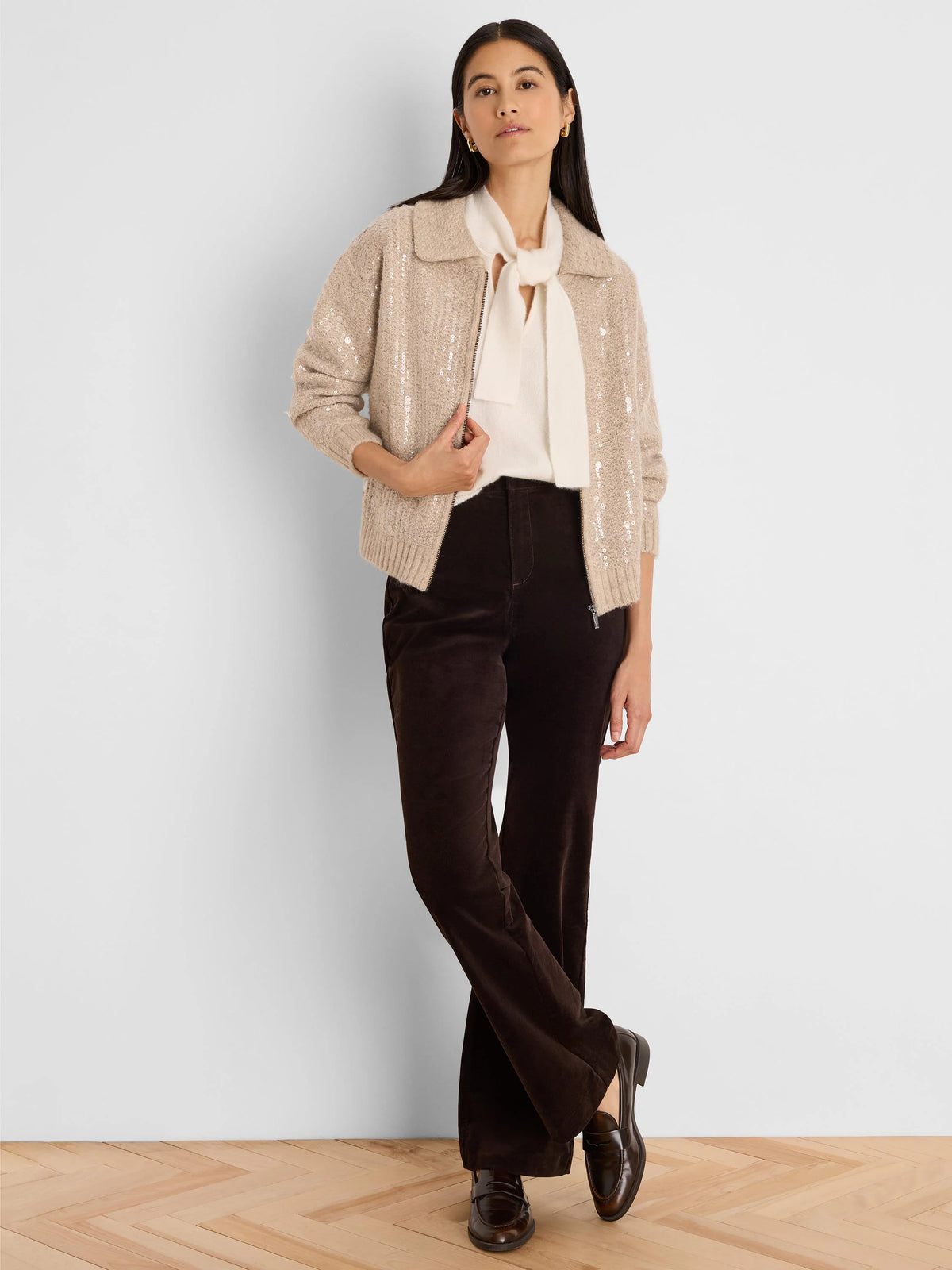 Tan knit jacket with all-over sequins, featuring a zip front and flat collar.