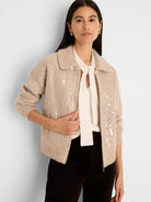 Light beige knit jacket with scattered clear/silver sequins, a collar, and front zipper.