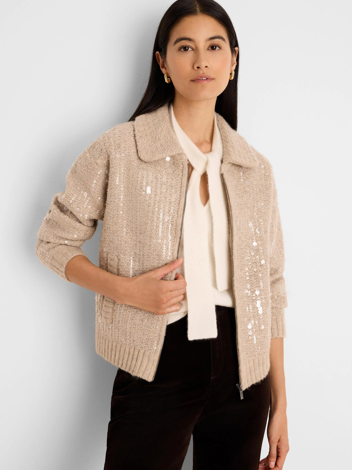 Light beige knit jacket with scattered clear/silver sequins, a collar, and front zipper.