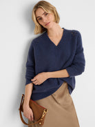Fuzzy deep blue V-neck sweater with openwork shoulder details.
