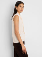 Cream cashmere blend sleeveless tank with a high neckline and bow ties.