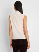 Cream sleeveless mock neck tank with ribbed hem, shown from the back. Soft, fuzzy texture.