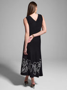 Black midi dress, sleeveless, V-neck.  White embroidered detail at hem.