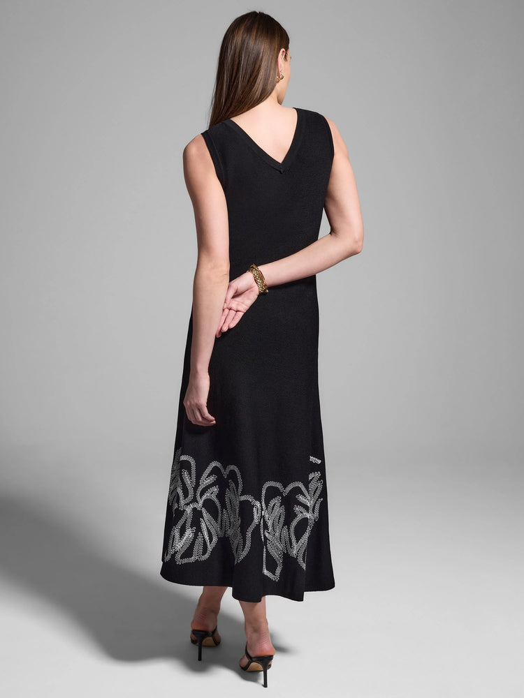 Black midi dress, sleeveless, V-neck.  White embroidered detail at hem.