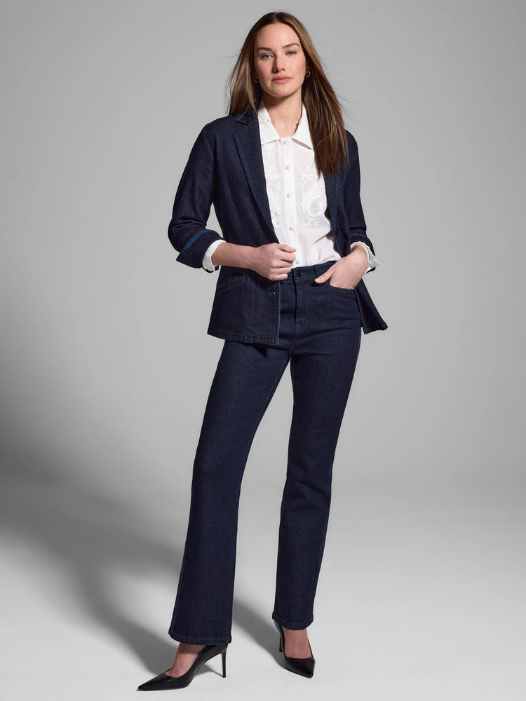 Dark wash denim blazer with gold trim;  cuffs and lapels show contrast stitching. Model also wears white shirt and dark...