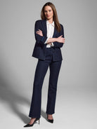 Dark wash denim jeans with gold ribbon trim along the sides; flared leg.