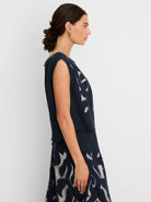 Navy linen sleeveless top with light underlayer showing through an organic cut-out pattern.