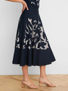 Navy midi skirt with beige-backed floral cut-outs.