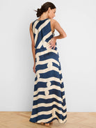 Navy and cream sleeveless maxi dress with a wavy stripe and circle pattern, gathered waist.