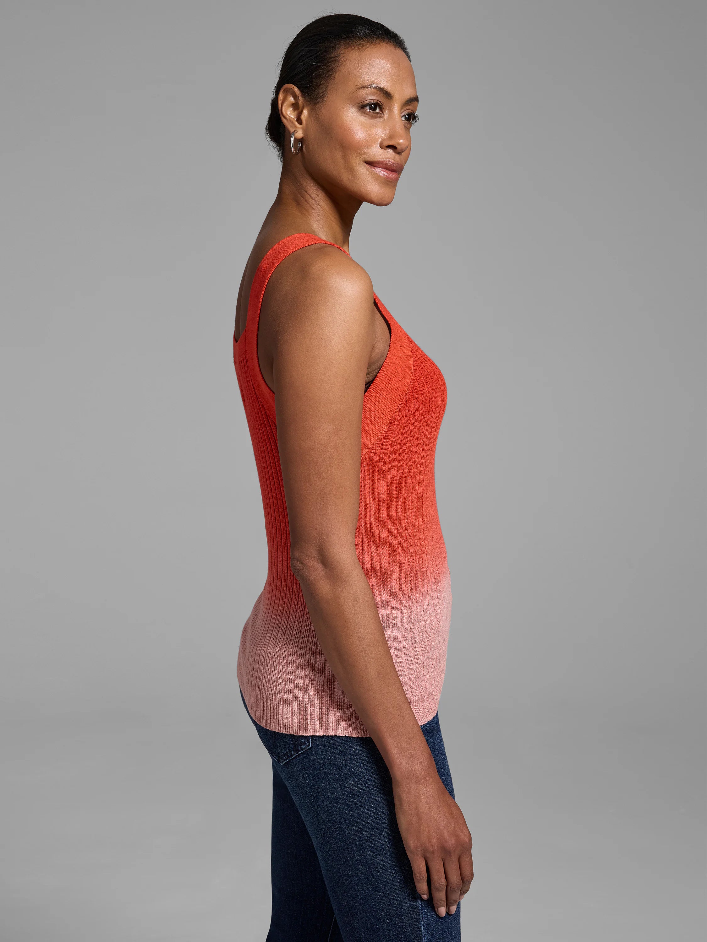 Ribbed knit tank top; ombre design transitioning from coral to light pink. Sleeveless, scoop neck.