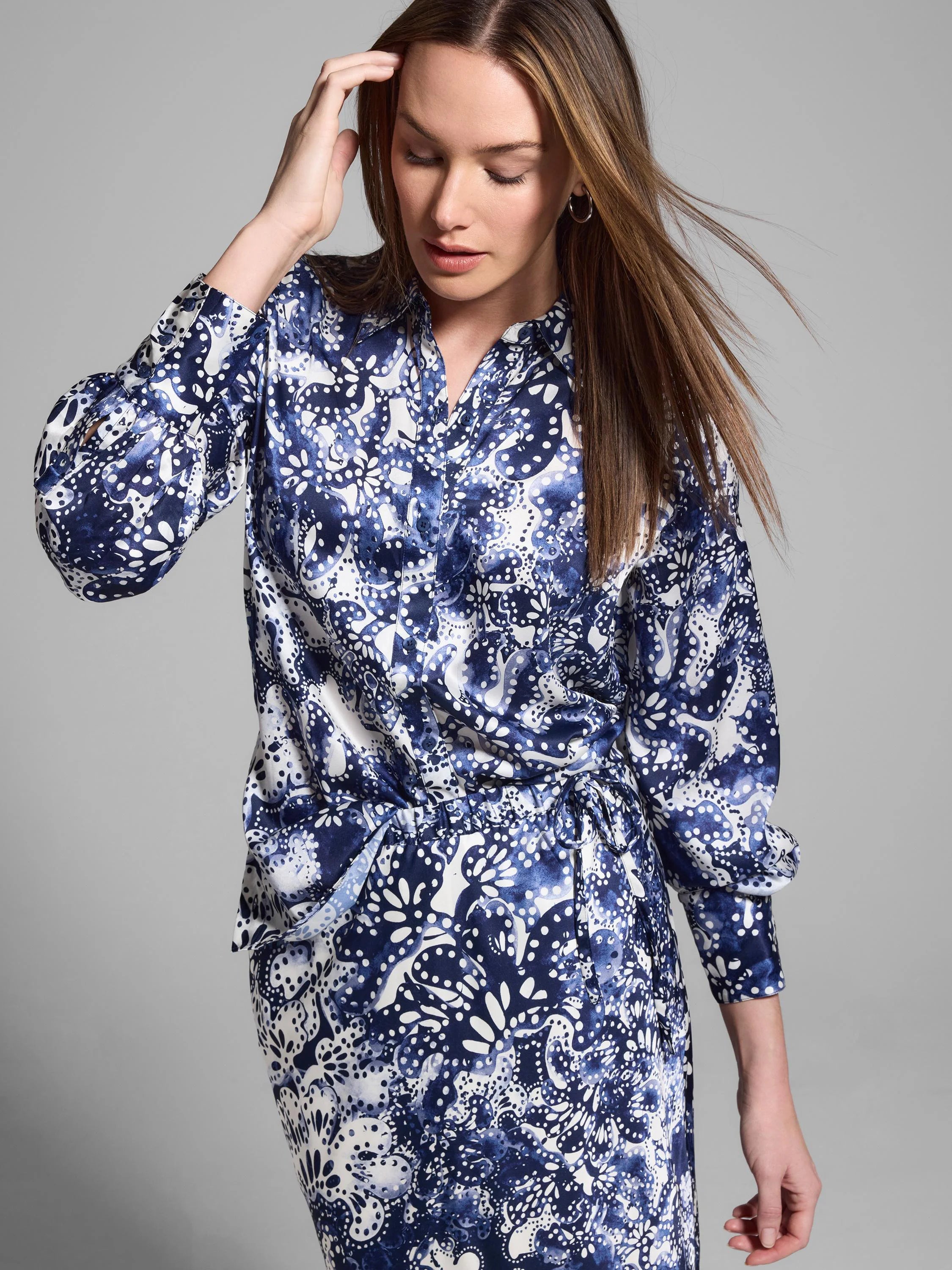 Silk shirt; long sleeves, button-front. Blue, white floral print on off-white background.