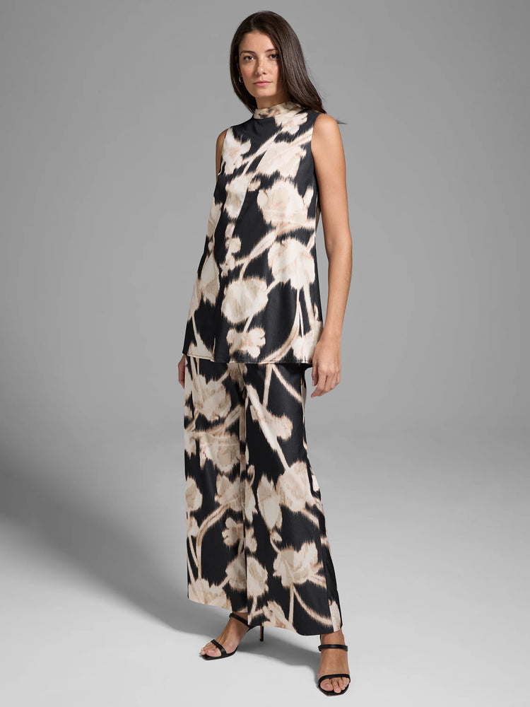 Black sleeveless top and wide-leg pants.  Beige and black floral print. High neck top.