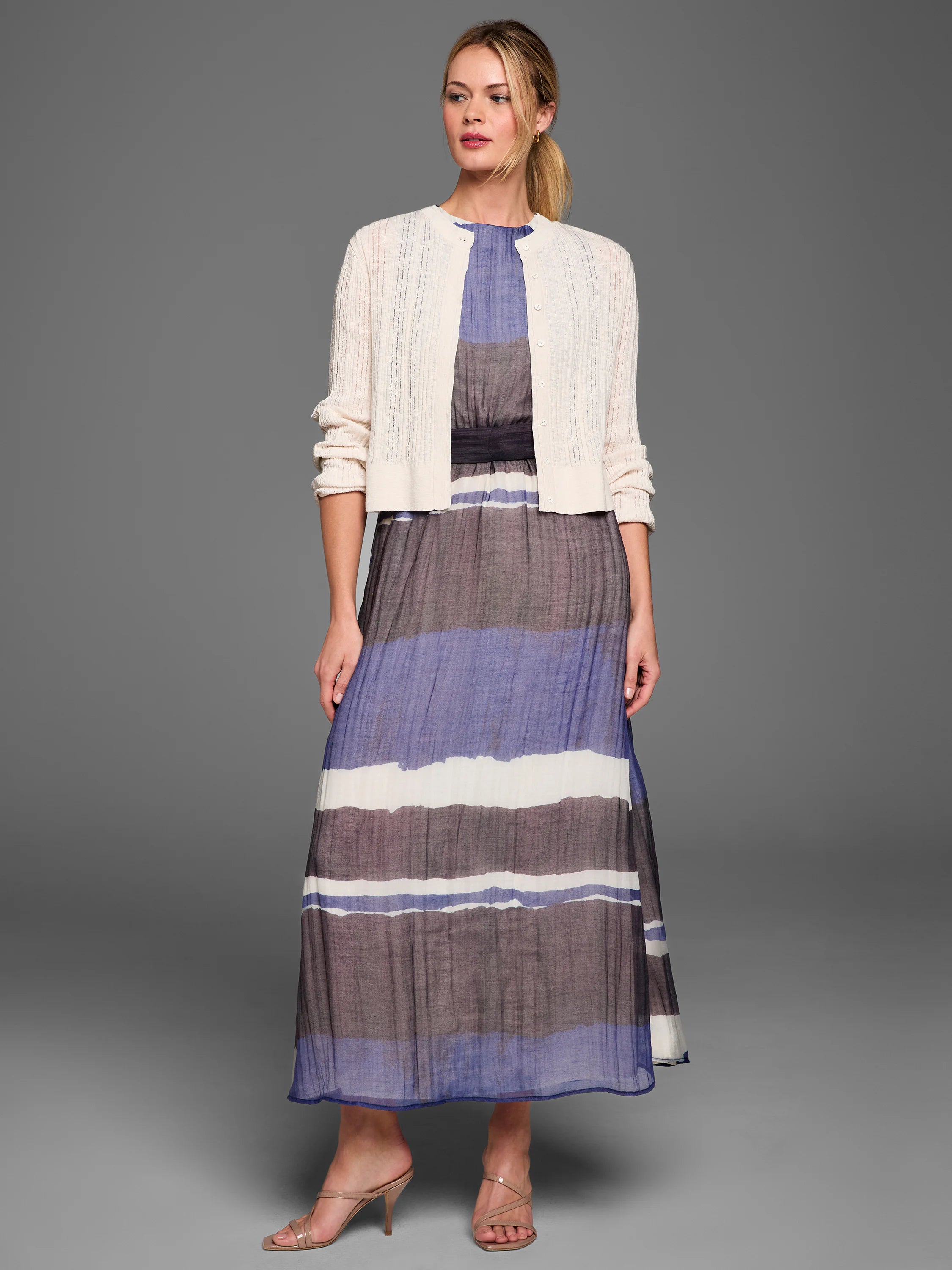 Off-white pointelle stitch cardigan. Cropped, open-knit design with front buttons.