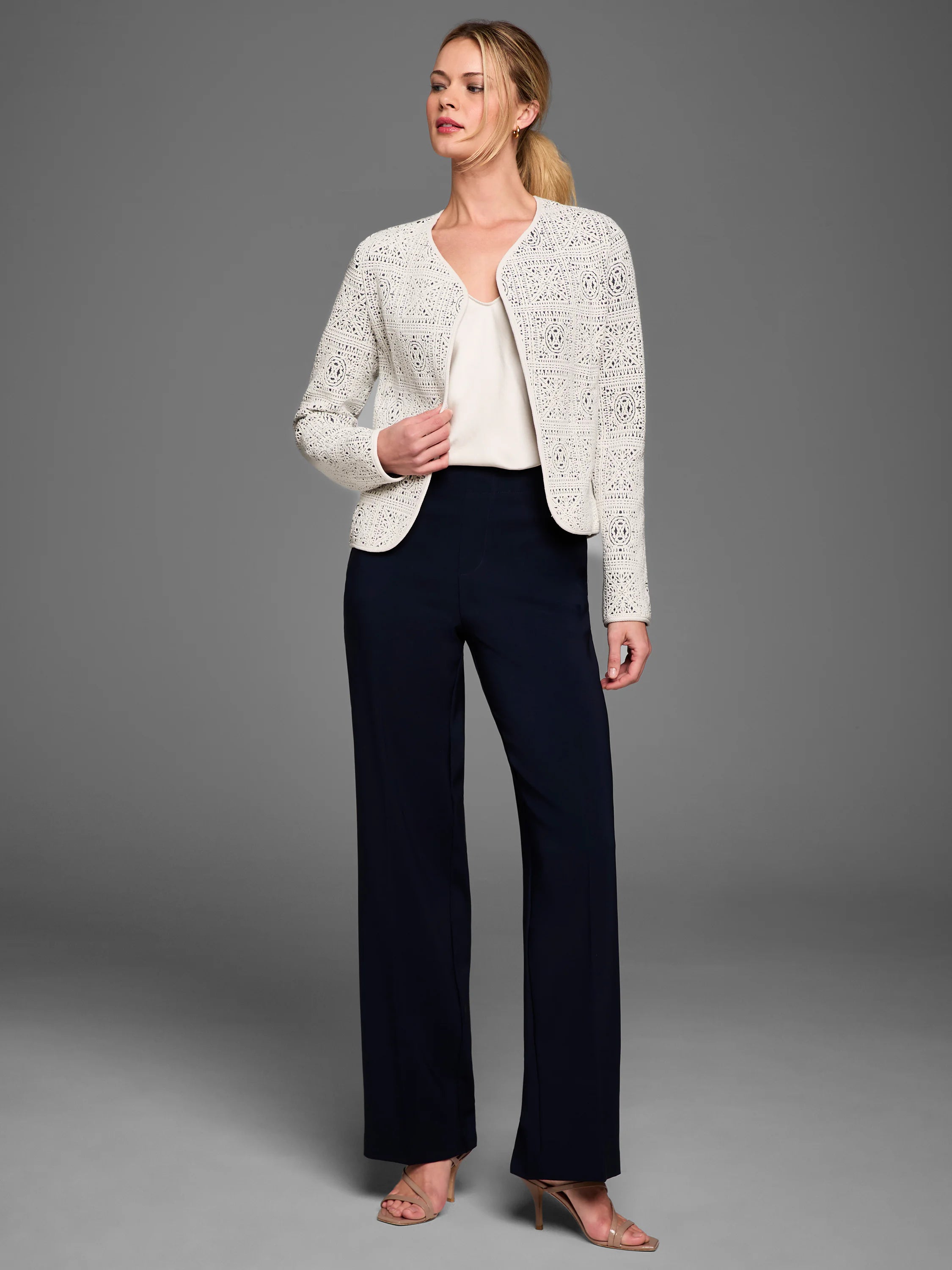 Off-white tapestry knit jacket with intricate geometric patterns and an open front.