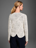Cream tapestry knit jacket, back view. Features dark intricate geometric patterns throughout and diagonal seams.