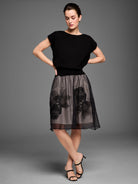 Black sheer mesh midi skirt over tan lining, with black embroidered abstract floral patterns.