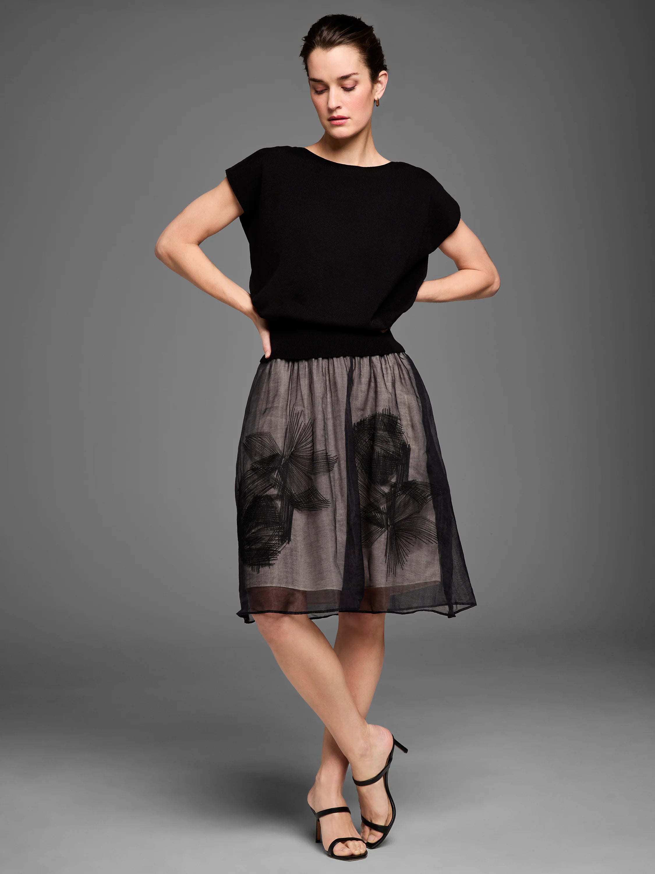 Black sheer mesh midi skirt over tan lining, with black embroidered abstract floral patterns.