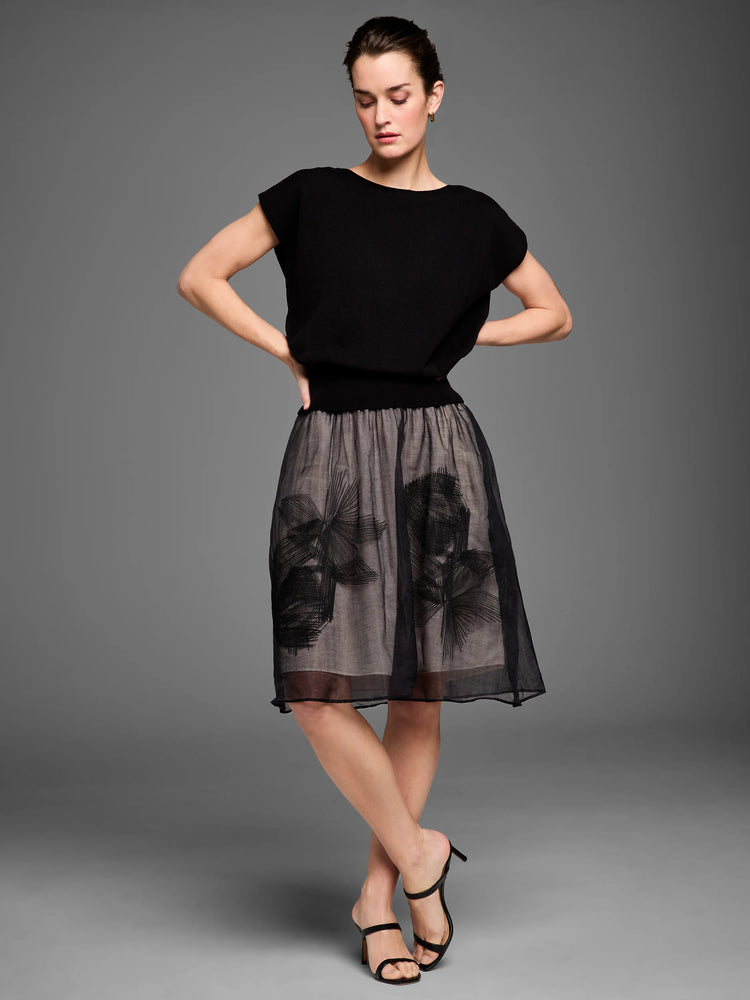 Black sheer mesh midi skirt over tan lining, with black embroidered abstract floral patterns.