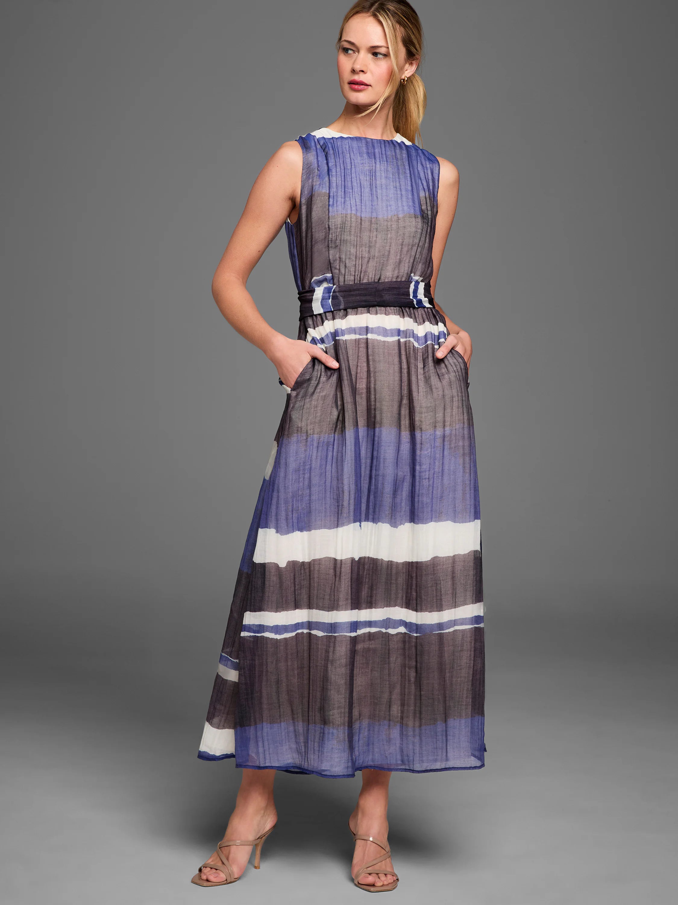Long dress with horizontal blue, white, and dark grey stripes. Features a tie waist and side pockets.