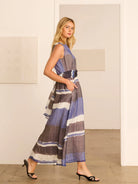 Sleeveless V-neck maxi dress with horizontal stripes in blue, charcoal, and white. Features a belted waist and side pockets.