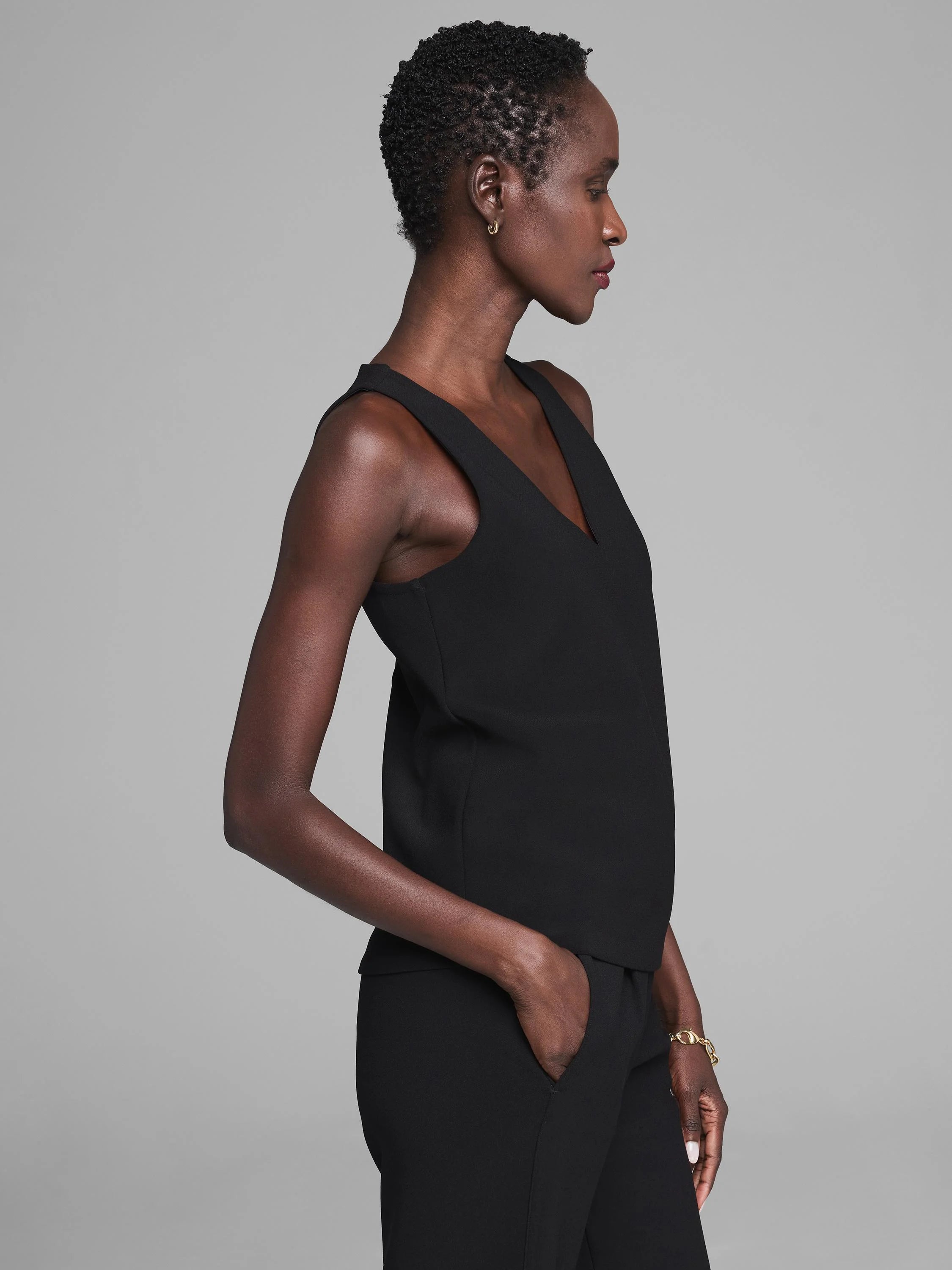 Black V-neck knit scuba tank on model, with wide straps and a relaxed fit.