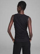 Black sleeveless jersey tank with prominent diagonal and vertical draping on the back.