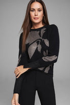 Black sweater with large, muted gold floral knit pattern.