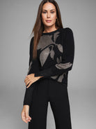 Black knit sweater with a metallic gold floral pattern.