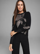 Black knit sweater with a metallic gold floral pattern.
