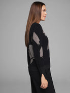 Black knit sweater with light gray floral pattern.  Slight shimmer on cuffs and hem.