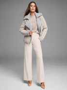 Beige, grey, off-white houndstooth knit jacket with fuzzy grey collar, cuffs, and asymmetrical zip trim.