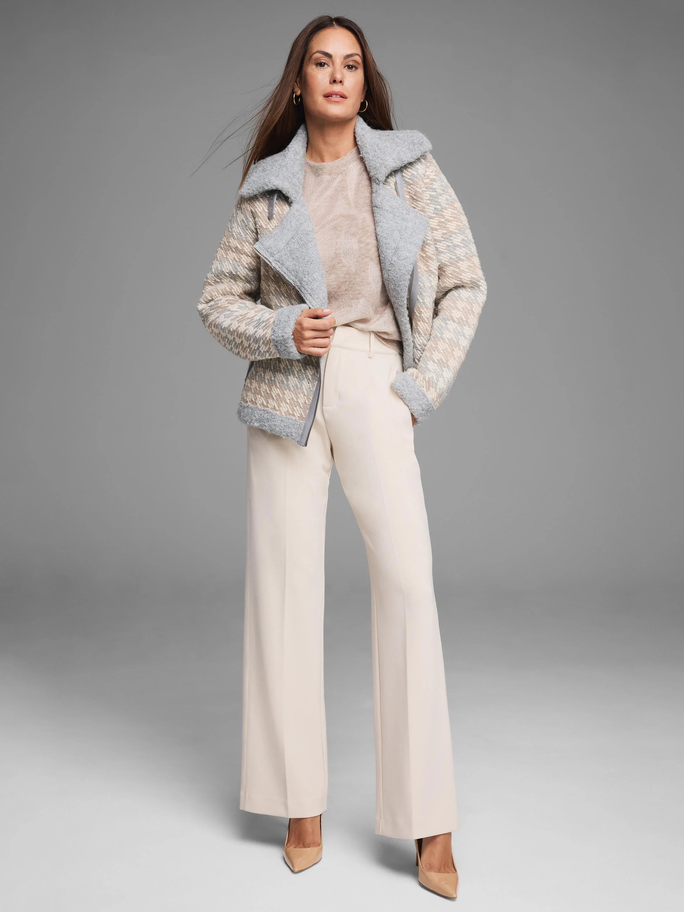 Beige, grey, off-white houndstooth knit jacket with fuzzy grey collar, cuffs, and asymmetrical zip trim.