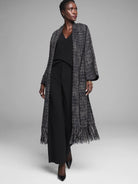 Black & white tweed jacket with metallic threads. Long duster style, prominent fringe on front and hem.