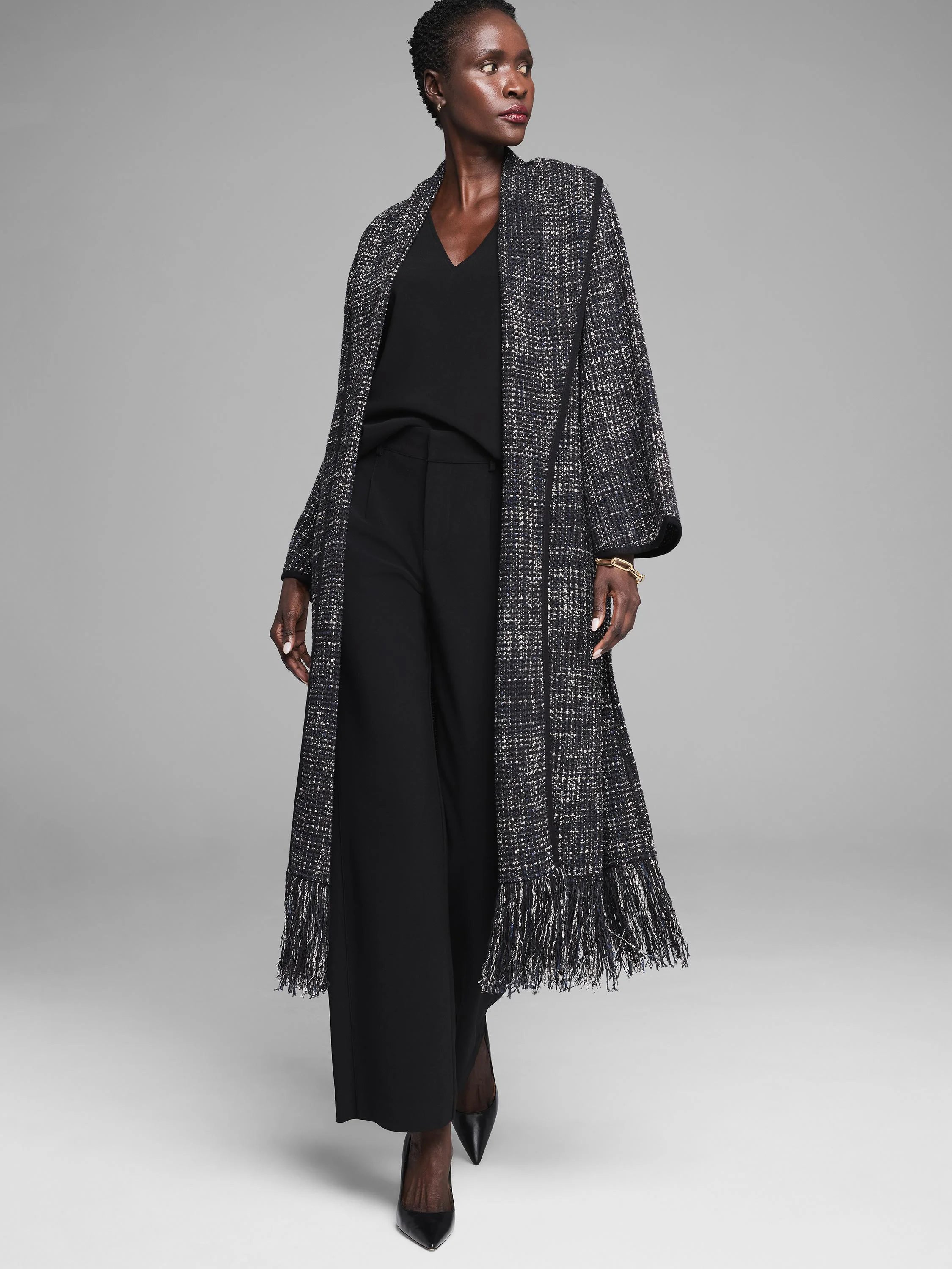 Black & white tweed jacket with metallic threads. Long duster style, prominent fringe on front and hem.