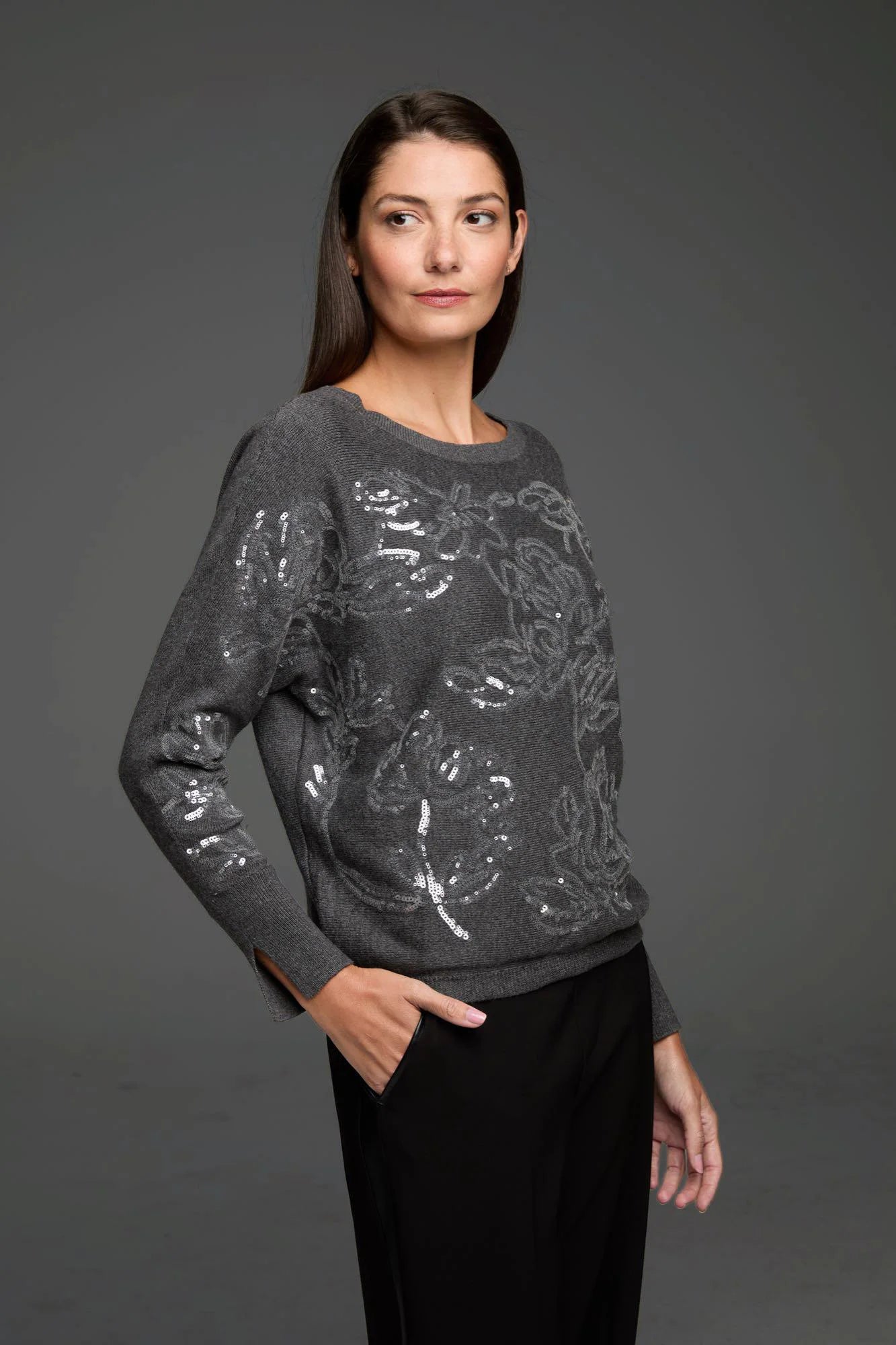 Dark gray knit sweater with silver sequin floral pattern, round neck, long sleeves with slit cuffs.