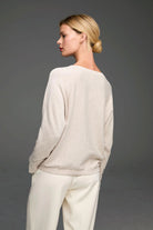 Light beige long-sleeve sweater. Features a relaxed fit, wide neckline, and ribbed cuffs and hem.