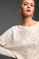Oatmeal crew neck sweater features an all-over taupe embroidered floral pattern detailed with white sequins.