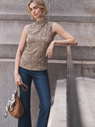 Bohemian bandana with cream, black, and tan paisley pattern, tied to a brown purse.