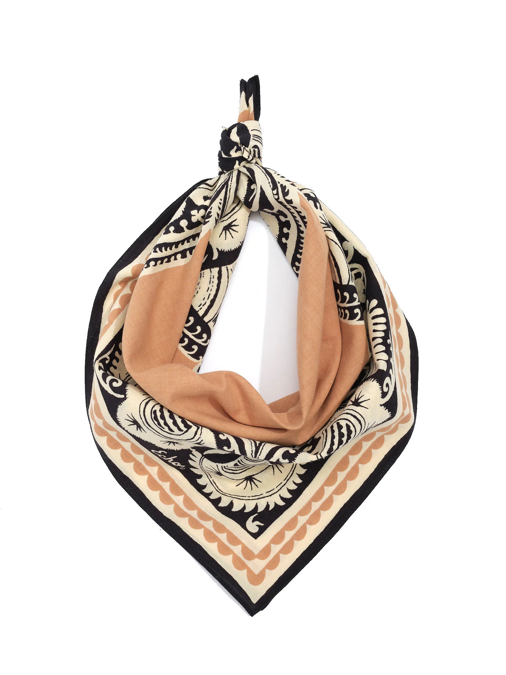 Folded bandana tied at top. Cream, black, and tan bohemian print with intricate designs and scalloped borders.