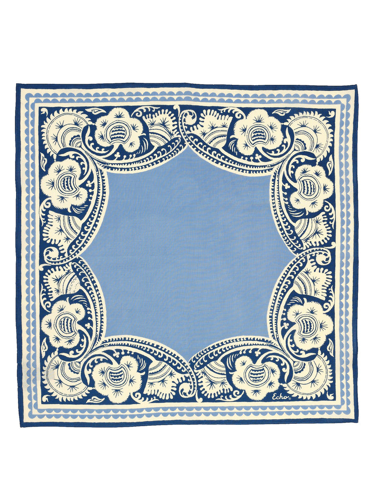 Square bandana. Sky blue center with a detailed navy blue & cream floral border.