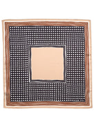 Square bandana with tan outer border, brown and white stripes. Dark navy with white polka dots surround a solid tan center.