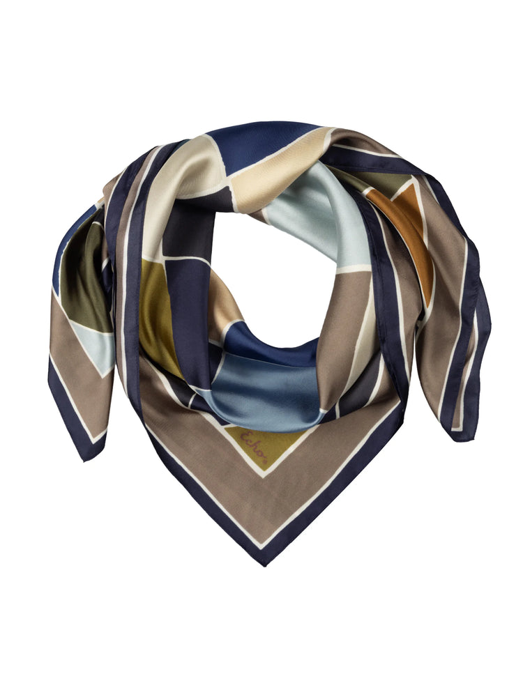 Silk scarf with geometric blocks in navy, brown, olive, light blue, and cream.