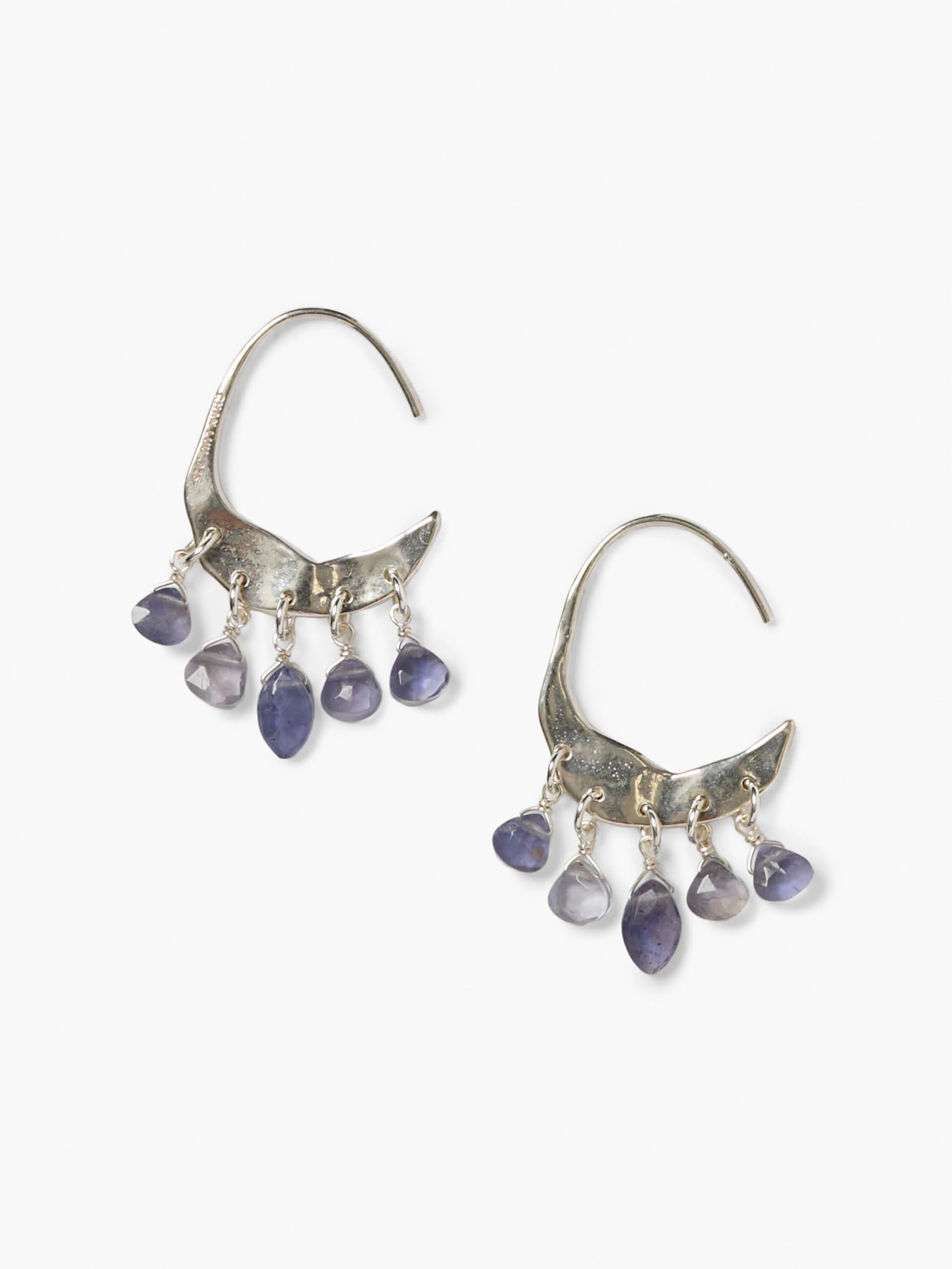 Silver crescent earrings, each with five dangling, faceted purplish-blue Iolite stones.