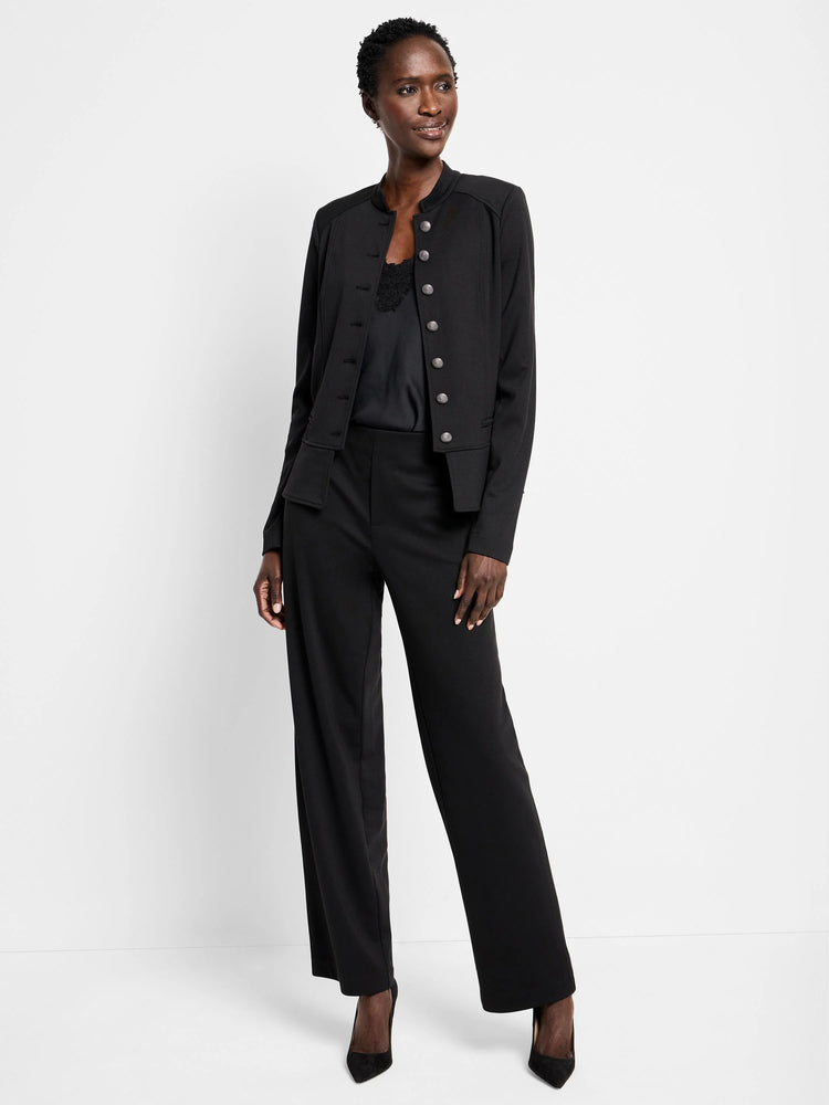 Black knit jacket with a band collar and a double row of silver buttons. Hip-length.