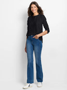 Black lace knit long-sleeve tee with a round neck and relaxed fit, shown on a model.