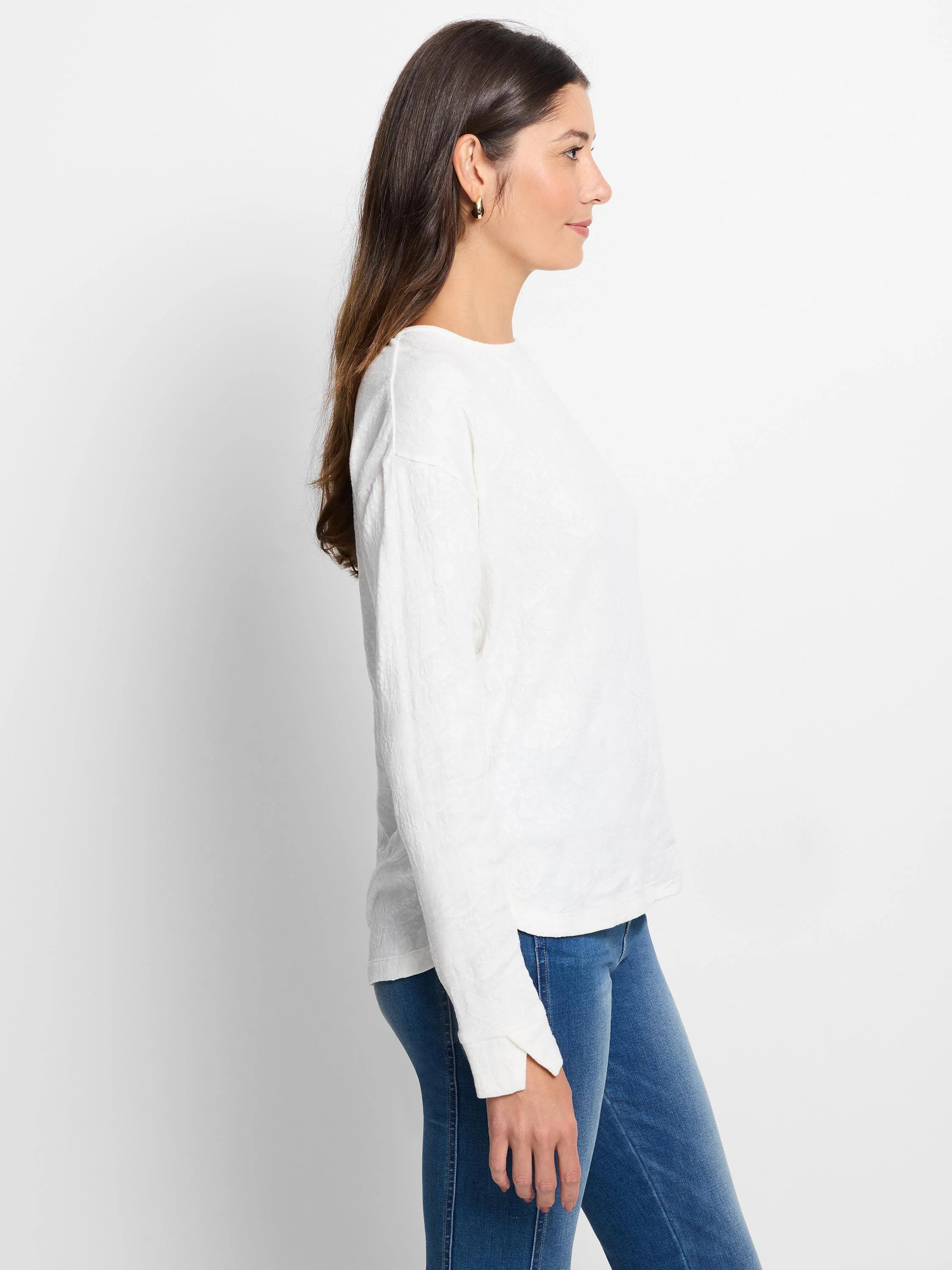 Cream lace knit tee, subtly textured. Features long sleeves, a crew neck, and a relaxed fit.