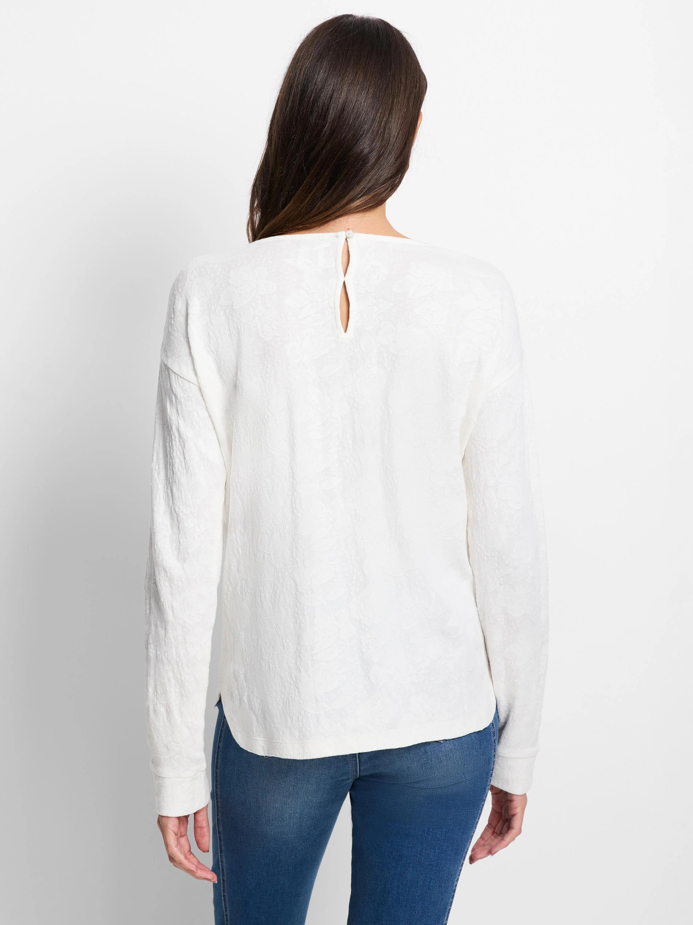 Off-white long-sleeve tee with subtle lace knit pattern. Keyhole opening with button at the back neck.