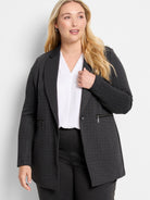 Charcoal gray knit jacket with white pinstripes, a button closure, and two zippered pockets.