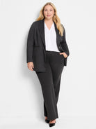 Dark gray knit pinstripe jacket, worn open, with a decorative zip pocket on the left.