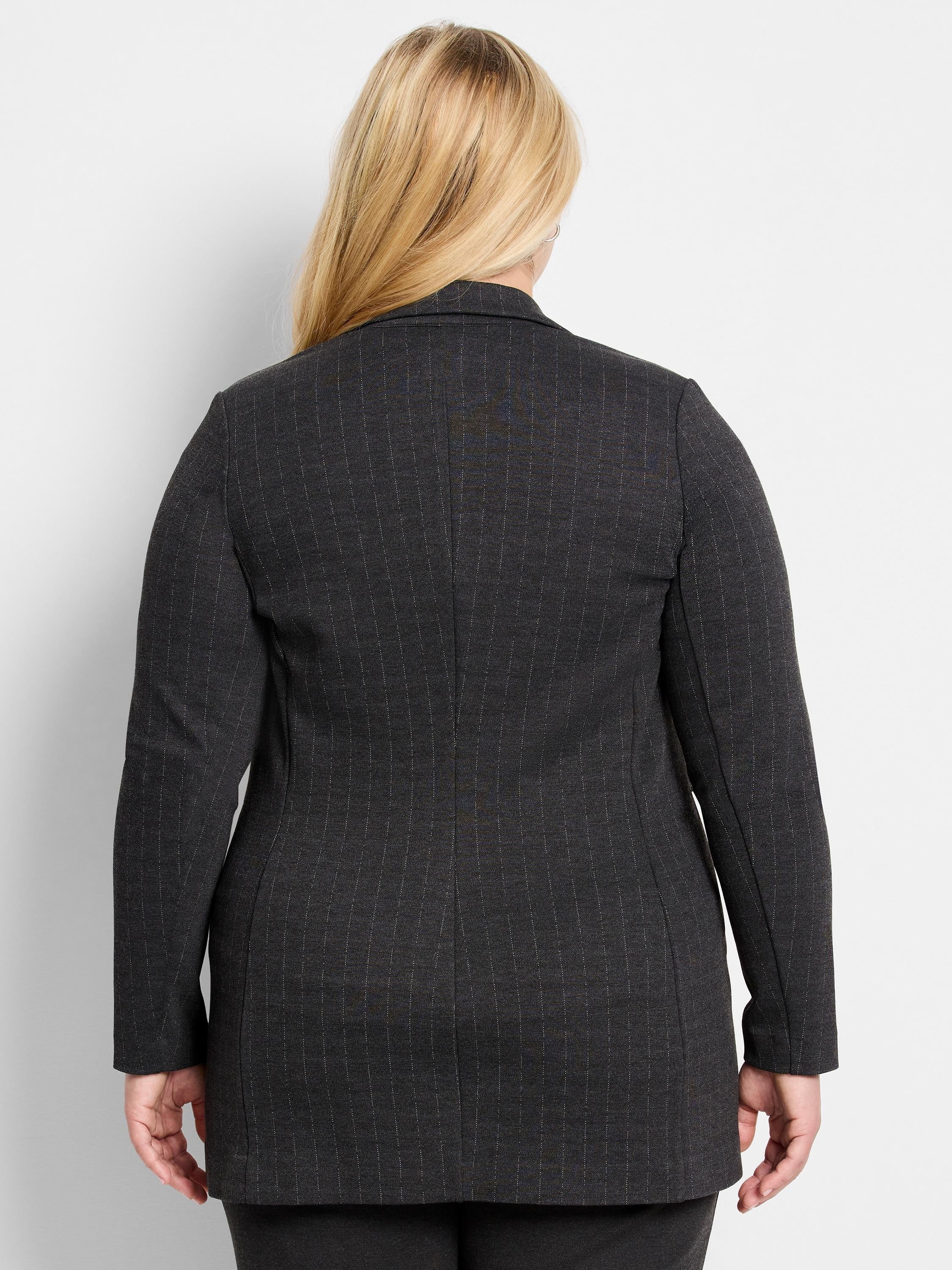 Back of a dark grey knit jacket with thin white pinstripes.